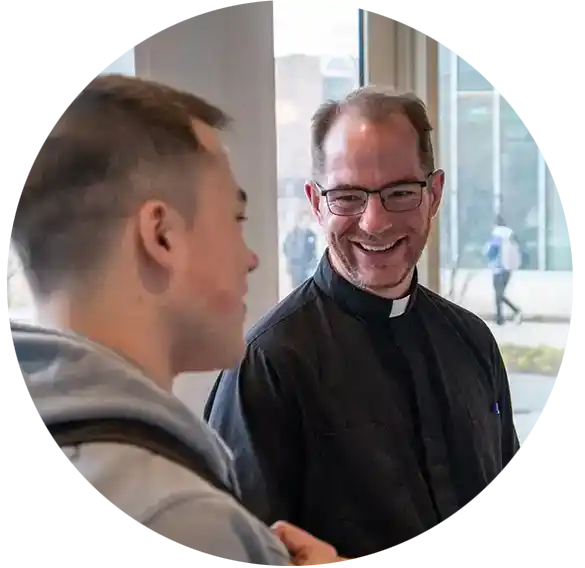 A student and a Jesuit on the Marquette University campus.