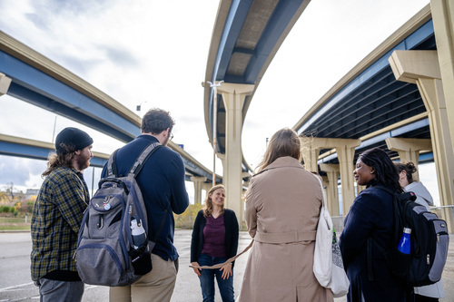 group of students and teacher under milwaukee highways